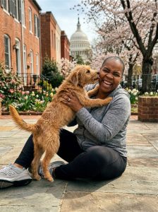 Dog walker and dog on a private one-on-one walk in Capitol Hill DC on a sunny morning